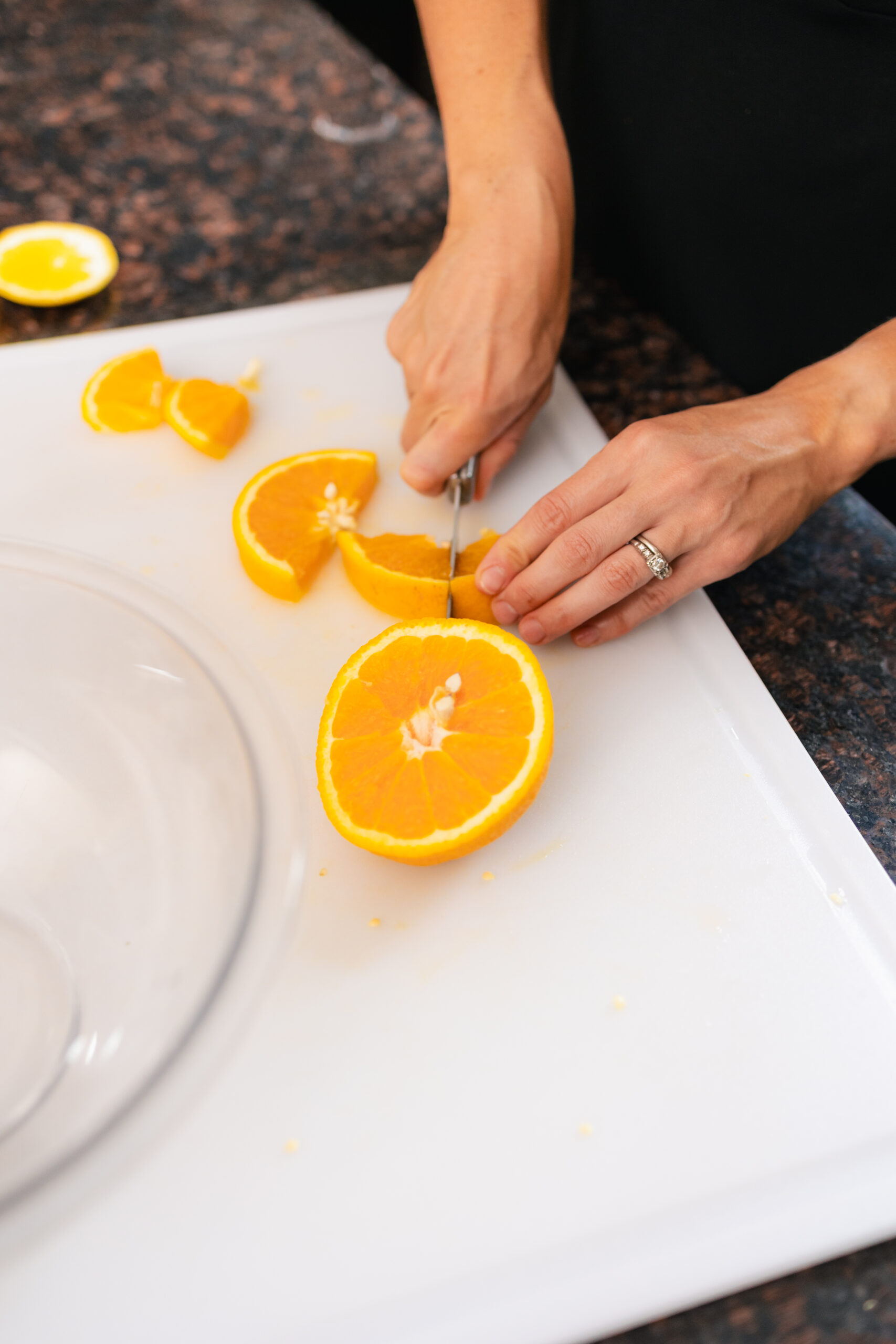 Fresh orange being sliced on a cutting board, representing heart-healthy nutrition and cholesterol-friendly eating for cardiovascular wellness